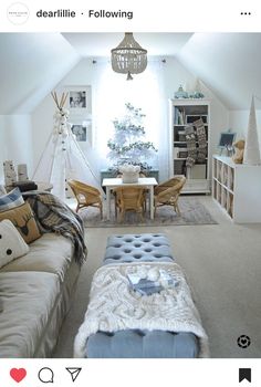 a living room filled with furniture next to a white table and chair covered in blankets