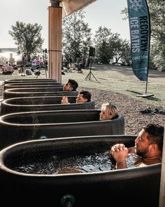 several people sitting in an outdoor hot tub