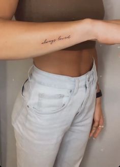 a woman with a tattoo on her arm that says, always be brave in cursive writing