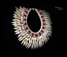 a necklace made out of white and red beads