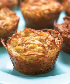 a close up of a muffin on a plate with other pastries in the background