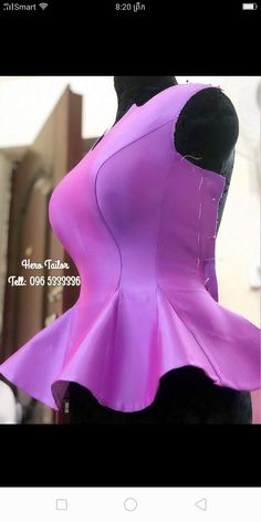 the back of a woman's purple corset is shown in this screenshot