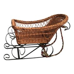 a small wicker basket on a metal stand with wheels and handles, isolated against a white background