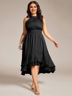 a woman wearing a black dress and heels