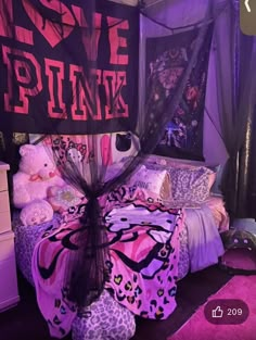 a bed with pink and black decor in a room that says love punk on it