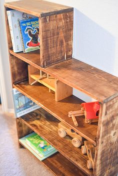 a bookshelf made out of pallet wood with toys on the bottom shelf