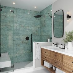 a bathroom with green tiles on the wall and wooden cabinetry in the shower area