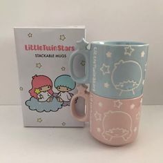 two little twin stars mugs sitting next to each other in front of a box