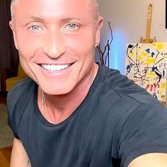 a bald man with blue eyes smiling at the camera