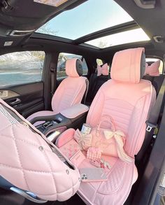 the interior of a car with pink leather seats and bows on the front row seat