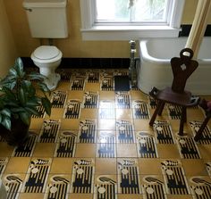 a bath room with a toilet a tub and a plant on the floor in front of a window