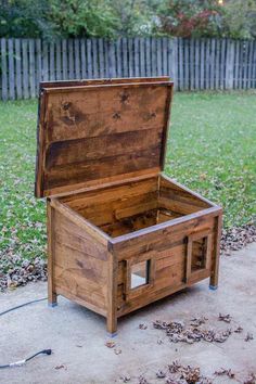 an open wooden box sitting on the ground