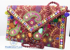 This beautiful Colorful clutch bag is handmade in Morocco. This bohemian Moroccan tassel clutch bag is fun and colorful. The embroidered clutch is the perfect accessory to carry with you for parties and other festive occasions. This beautiful little hippie clutch purse is handmade with embroidered fabric, venetian patterns and colorful pom pom's to trim. This Pom Pom clutch bag features a magnet opening and a zippered pocket inside. This adorable little floral crossbody bag will be sure to turn a few heads with its colorful features! This Colorful Clutch is the ultimate boho-chic accessory. This gorgeous bohemian clutch bag is the perfect accessory to give a unique look to your casual outfits or night out events. Can be also used as an amazing iPad case. Handcrafted by talented artisans us Bohemian Clutch Bag With Tassels, Festival Bags With Tassels As Gifts, Bohemian Tassel Clutch Bag, Handmade Bohemian Evening Bag For Festive Occasions, Bohemian Rectangular Evening Bag For Festivals, Handmade Multicolor Evening Bag For Festivals, Multicolor Handmade Evening Bag For Festivals, Bohemian Clutch Shoulder Bag With Tassels, Bohemian Pouch Clutch For Festive Occasions