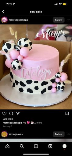 a pink and black cake sitting on top of a table