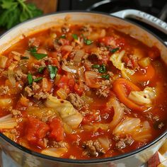 a pot filled with meat and vegetables on top of a table