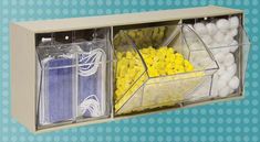 two clear bins filled with yellow and white candies on top of a blue background