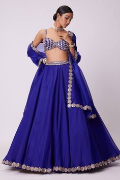 Blue flared attached cancan lehenga with mirror hand embroidery. Paired with a padded mirror embroidered blouse and dupatta with mirror embroidered border. - Aza Fashions Party Choli With Gota Work On Organza, Party Organza Choli With Gota Work, Festive Royal Blue Sets With Mirror Work, Blue Organza Lehenga With Mirror Work, Blue Art Silk Sets With Mirror Work, Blue Art Silk Party Dress, Blue Kundan Sets With Mirror Work, Traditional Embellished Royal Blue Sets, Blue Mirror Work Lehenga For Party