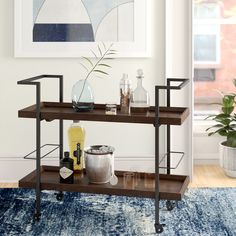 a living room with a blue rug and two shelves