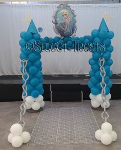 an arch made out of balloons and chains with the words sweet treats on it in front of a backdrop