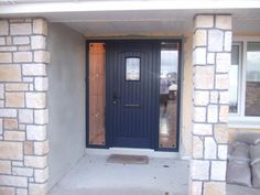 a blue front door with two pillows on the porch