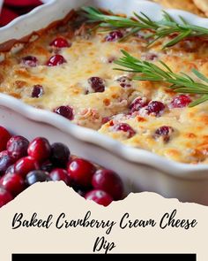 baked cranberry cream cheese dip with rosemary sprigs in a white casserole dish