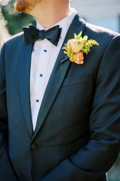 a man in a tuxedo with a boutonniere on his lapel