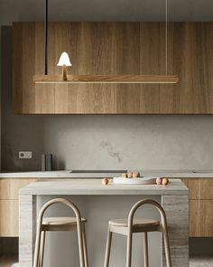 two stools are in front of a kitchen island