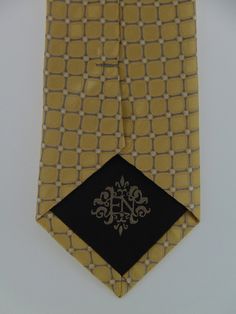 "Men's 100% silk gold necktie is the perfect tie for the big wedding day or everyday. This gold tie available as a extra long Neck Tie. Handmade from 100% silk, this special collection features a .75\" Eds Neckties logo at the bottom right front corner of every tie and a larger logo located on the tipping (Back of the tie). The label features the collection name (Nathaniel Alexandria) Named after my son Nathaniel and my daughter Alexandria. Expertly hand-made from 100% silk you can select your l Luxury Gold Tie For Formal Occasions, Elegant Formal Ties For Father's Day, Classic Gold Tie For Formal Occasions, Luxury Gold Tie For Black Tie Events, Classic Gold Suit And Tie Accessories For Black Tie, Elegant Gold Tie For Black-tie Events, Elegant Ties For Black Tie Events And Father's Day, Classic Fitted Gold Ties, Elegant Black Tie For Father's Day