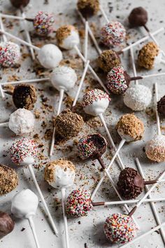 chocolate covered marshmallows and sprinkles on a white table top