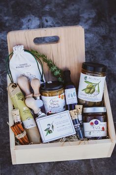 a wooden box filled with lots of food and condiments on top of a table