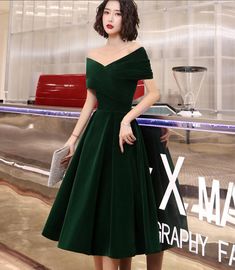 a woman in a green dress posing for the camera