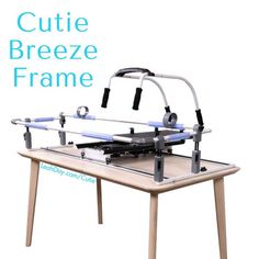 the cutie breeze frame is sitting on top of a wooden table with two handles