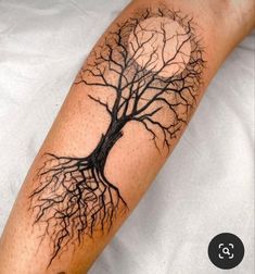 a man's arm with a tree tattoo on it