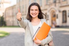 a woman holding a folder and giving the thumbs up