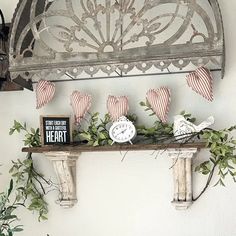 a shelf with some decorations on it and an american flag hanging from the wall above