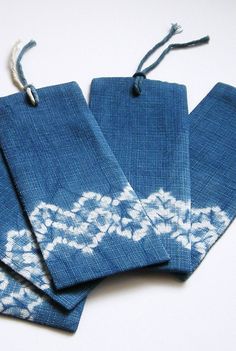 three blue bags with white designs on them