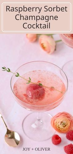 raspberry sorbet champagne cocktail in a glass with ice and garnish