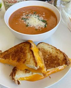 a bowl of soup and two grilled cheese sandwiches