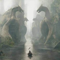 a person sitting on a boat in the middle of a river surrounded by giant animals