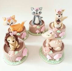 there are four small figurines in the shape of animals