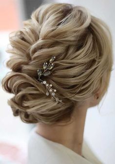 a woman with blonde hair wearing a wedding hairstyle