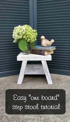 a small table with flowers and books on it that says, easy one - board step stool