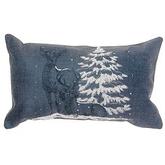 a black and white pillow with an image of a deer in the snow on it