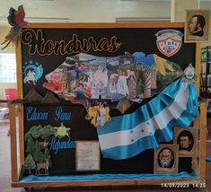 a sign with pictures and flags on it in a room filled with other memorabilias