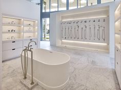 a large white bathtub sitting inside of a bathroom next to a walk in shower