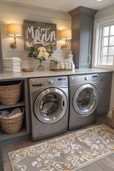 a washer and dryer in a laundry room next to a window with flowers on it