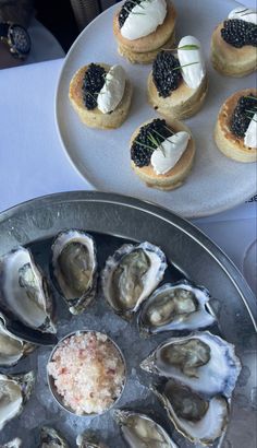 there are many different types of food on this plate and in the middle one is oysters