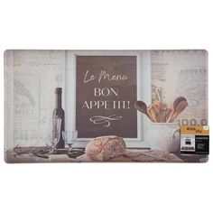 a kitchen mat with bread and wine in front of a window that says le menu bon appeti