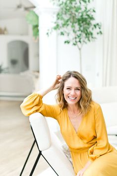 a woman sitting on top of a white couch