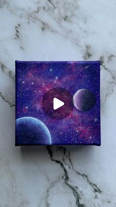 a box with an image of planets on it and a video player in the middle